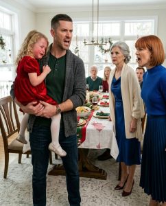 During Christmas dinner, my daughter accidentally knocked juice onto the table. My mother-in-law sla:pped her in front of the whole family. I rose from my chair, trembling with rage, but my wife shouted, “She deserved it!” Not one person protected my little girl. So I lifted her into my arms and left. By the next morning, they were pleading for me to return.At Christmas dinner, my six-year-old daughter, Lily, tipped cranberry juice across my mother-in-law’s white tablecloth.

It had been an accident.

Her small elbow hit the glass as she reached for a dinner roll. The red juice spilled, spread quickly, and ran over the edge of the table like a miniature crime scene. Lily went completely still with both hands raised, her blue eyes huge, her mouth already beginning to tremble.

“I’m sorry,” she whispered. “Grandma, I’m sorry. I didn’t mean—”

The slap echoed through the dining room before she could finish speaking.

My mother-in-law, Patricia Whitmore, had shot to her feet so suddenly that her chair scraped loudly behind her. Her palm struck Lily’s cheek with enough force to turn my daughter’s face to the side.

For one whole second, nobody seemed to breathe.

At first, Lily did not even cry. She only stared in shock, one hand slowly lifting toward her cheek.

Then the tears started.

I felt something rip open inside my chest.

“What the hell is wrong with you?” I shouted, shoving back from the table so hard my chair toppled over.

My wife, Claire, stood as well.

But she did not stand with me.

She stood with her mother.

“She deserved it!” Claire screamed.

The room turned colder than the December night beyond the windows.

My brother-in-law Marcus lowered his eyes to his plate. His wife, Anna, looked down into her wine glass. Claire’s father, Robert, cleared his throat but stayed silent. Even my own father, who had been invited because he had nowhere else to spend the holiday that year, sat quietly at the far end of the table.

Nobody defended Lily.

Nobody spoke up.

Lily looked at me, crying softly now, confused in the heartbreaking way only a child can be confused by adults who are supposed to protect her.

“Daddy,” she sobbed, “am I bad?”

That shattered me.

I moved around the table, picked her up, and pressed her against my chest. Her little body trembled. I could feel the warmth spreading across her cheek where Patricia had struck her.

Claire’s expression hardened. “Daniel, don’t you dare make a scene.”

I looked at my wife as though I were staring at a stranger wearing her face.

“A scene?” I said. “Your mother hit our child.”

“She ruined dinner,” Patricia snapped. “Children need discipline.”

“She is six.”

“She is spoiled.”

I grabbed Lily’s coat from the hall closet with one hand while holding her with the other. Claire followed after me, furious.

“If you leave now,” she said, “don’t expect me to chase you.”

I pulled open the front door. Snow swept across the porch.

“I’m not asking you to.”

Then I carried my daughter out of that house.

By morning, their phones would not stop calling.

PART 2
I drove through the falling snow with one hand gripping the steering wheel and the other holding Lily’s mittened fingers.

She sat in the back seat wearing her red Christmas dress, her coat only half zipped, clutching the stuffed rabbit she had brought from home. Streetlight glow slid over her tear-stained face.

“Daddy,” she said after ten silent minutes, “Mommy thinks I’m bad.”

I swallowed hard.

“No, sweetheart.”

“But she said I deserved it.”

I looked at her through the rearview mirror. The red mark on her cheek had become darker.

“Sometimes grown-ups say terrible things when they are angry,” I said carefully. “But you did not deserve to be hit. Not for spilling juice. Not for anything.”

She nodded, but I could tell she was not ready to believe me.

I did not drive her home. Claire had keys. Patricia had keys. And for the first time in our eight-year marriage, our own house did not feel safe.

I drove to a hotel near the interstate, the kind with yellow lighting, an exhausted front desk clerk, and a vending machine buzzing beside the elevators. I checked in under my name, carried Lily upstairs, and helped her change into one of my T-shirts because her pajamas were still at home.

Her cheek was swollen.

I took photographs.

My hands trembled while I did it.

Not because I wanted revenge. Not yet. I was shaking because I finally understood what I had been refusing to see for years.

Patricia had always been cruel in smaller ways.

She picked at Lily’s hair, her manners, her appetite, her handwriting. Claire always brushed it aside.

“That’s just Mom.”

“She means well.”

“She was raised differently.”

“She’s hard on people she loves.”

And I had accepted those explanations because they were easier than arguing with my wife.

But that night, looking at my daughter’s cheek under the bathroom light, I realized my silence had helped create the problem.

At 11:43 p.m., Claire called.

I let it ring.

At 11:45, she called again.

At 11:52, Patricia called.

Then Robert.

Then Claire again.

Finally, a text appeared.

Claire: You embarrassed me in front of my family.

I stared at the screen until my vision blurred.

Then I typed back:

Daniel: Your mother hit Lily. You defended it. Do not contact us tonight unless you are ready to apologize to our daughter.

Three dots appeared.

Then vanished.

Then appeared again.

Claire: You’re being dramatic.

I turned my phone off.

Lily fell asleep around one in the morning with her head resting on my arm. I stayed awake, staring up at the ceiling, listening to the heater switch on and off.

At 6:18 a.m., I powered my phone back on.

Twenty-seven missed calls.

Fourteen texts.

One voicemail from Claire.

Her voice sounded different now. Smaller.

“Daniel, please call me. Mom says she didn’t mean to hit her that hard. Dad is upset. Everyone is upset. Just come back so we can talk like adults.”

Then there was a text from Robert.

Robert: Please come back. Patricia is crying. Claire has been crying all morning. This has gone too far.

I looked at Lily sleeping next to me, her cheek still marked by Patricia’s hand.

No.

It had not gone too far when I walked out.

It had gone too far the moment nobody stood up for my child.

PART 3
Instead, I ordered pancakes from room service, sat with Lily at the small hotel table, and watched her attempt to smile through the soreness in her cheek.

She poured syrup with extreme care, both hands wrapped around the little glass bottle.

“I won’t spill,” she said.Motherhood support groups

Those words struck harder than the sound of the slap.

I put my fork down.

“Lily.”

She looked up at me.

“You are allowed to make mistakes.”

Her lower lip trembled.

“Even at Grandma’s house?”

“Especially at Grandma’s house,” I said. “Spilling juice is a mistake. Hitting someone is a choice.”

She stared at her pancakes for a long moment.

Then she whispered, “I don’t want to go back there.”

“You won’t,” I said.Child care services

The words came out before I had a chance to soften them. But once I said them, I knew they were true.

My phone buzzed again. Claire.

This time, I answered.

“Where are you?” she demanded immediately.

I heard the old Claire in her tone, the one who believed anger could pass for authority.

“Safe,” I said.

“That’s not an answer.”

“It’s the only one you’re getting right now.”

She let out a sharp breath. “Daniel, this is insane. My mother made a mistake.”

“No,” I said. “Lily made a mistake. Your mother assaulted a child.”

Silence fell over the line.

Then Claire said, “Don’t use that word.”

“Why? Because it sounds ugly?”

“Because you’re making her sound like some kind of criminal.”

“She hit a six-year-old across the face.”

“She was stressed. It was Christmas. The tablecloth was expensive. Lily was acting wild all night.”

I looked at Lily. She was quietly cutting her pancake into tiny squares, trying not to listen.

“She was not acting wild,” I said. “She laughed too loudly during a card game and asked for extra whipped cream. That’s what children do.”

Claire lowered her voice. “Can you please come home so we can talk privately?”

“I’ll come to the house later to get Lily’s things. You don’t need to be there.”

“That is my daughter too.”

“Then start acting like it.”

She gasped as though I had struck her.

Maybe, in a sense, I had. Not with my hand, but with the truth she had spent years avoiding.

“My mother raised me that way,” Claire said. “I turned out fine.”Motherhood support groups

I closed my eyes.

There it was.

The sentence that explained everything and excused nothing.

“No, Claire,” I said quietly. “You learned to call fear respect. You learned to call pain discipline. You learned to protect the person who hurt you because admitting she was wrong would mean admitting you were hurt too.”

For the first time, Claire had no answer.

I could hear her breathing.

Then she said, much more softly, “You don’t know what you’re talking about.”

“Maybe not. But I know our daughter cried herself to sleep asking if she was bad.”

A small sound caught in Claire’s throat.

I kept going.Hospital emergency services

“And you told her she deserved it.”

“I was angry.”

“She will remember it.”

“Don’t say that.”

“She will. I know because I remember things my parents said when I was six.”

Claire began to cry then, but I did not comfort her. I had spent years comforting her after Patricia’s cruelty while pretending Lily was not watching the same pattern being handed down.

“I need time,” I said. “Lily needs space. I’m taking her to my sister’s in Vermont for a few days.”

“You can’t just take her out of state.”

“I can. I’m her father. And I’m telling you where we’ll be.”

“Daniel—”

“I’m also calling a family attorney.”

The crying stopped.

“What?”

“I’m not filing anything today. But I need to understand my options.”

“You’re threatening divorce over one slap?”

“No. I’m protecting our daughter after years of watching you choose your mother’s approval over our home.”

She hung up.

Two minutes later, Patricia called.

I rejected the call.

Then a text came through.

Patricia: You are destroying this family.

I typed back:

Daniel: You hit a child. You destroyed your access to mine.Child care services

I blocked her number.

For the first time since marrying into the Whitmore family, I felt like air could fully enter my lungs.

That afternoon, I drove to our house. I told Claire I would arrive at two. When I got there, her car was in the driveway. Robert’s was there too.

Patricia’s was not.

Good.

Claire opened the door before I knocked. She looked exhausted. Her eyes were swollen. The Christmas sweater she had worn the night before was wrinkled, and her hair was badly tied back.

Behind her, Robert stood in the living room with his hands in his pockets.

“Where’s Lily?” Claire asked.

“With my sister.”

Her face twisted. “You left her with Melissa?”

“Yes.”

“She barely knows Melissa.”

“She knows Melissa has never hit her.”

Claire flinched.

Robert stepped forward. “Daniel, please. Come in.”

I entered.

Not because I wanted peace. Because I needed Lily’s clothes, her school bag, her favorite blanket, and the purple nightlight she could not sleep without.

Claire followed me upstairs.

Inside Lily’s room, everything looked painfully ordinary. A half-built Lego castle sat on the rug. Her Christmas shoes rested near the closet. A drawing of our family was taped above her desk: me, Claire, Lily, and a crooked golden retriever we did not own but she badly wanted.

Claire picked up the drawing.

“She loves us,” she said.

“I know.”

“She needs both of us.”

“I know that too.”

“Then don’t break our family.”

I turned away from the dresser with Lily’s pajamas in my hands.

“Our family broke last night when you looked at our crying daughter and sided with the person who hurt her.”

Claire held the drawing against her chest.

“I panicked,” she said.

It was the first honest sentence she had given me.

I waited.

She sat down on the edge of Lily’s bed.

“When I was little,” she said, staring at the carpet, “Mom used to hit me for things like that. Spilling milk. Talking back. Crying too loudly. Dad never stopped her.”

Downstairs, something creaked. Maybe Robert shifting his weight. Maybe the house settling around old guilt.

Claire continued.

“I told myself it was normal. Then Lily spilled the juice, and for a second, I wasn’t her mother. I was me at eight years old, standing in front of Mom, knowing everyone expected me to agree with her.”Motherhood support groups

I said nothing.

Claire looked up at me.

“That doesn’t excuse it.”

“No,” I said. “It doesn’t.”

“I know.”

“You still said she deserved it.”

Her face collapsed.

“I know.”

The room became quiet.

“I want to see her,” she whispered.

“She is scared of you right now.”

Those words landed between us like a judgment.

Claire covered her mouth with her hand.

I packed Lily’s clothes. Her favorite blanket. Her nightlight. The spare bow for her rabbit. Her toothbrush. Her snow boots.

When I came downstairs, Robert was standing alone in the hallway.

“Claire’s in the bathroom,” he said. “She’s sick.”

I did not respond.

He rubbed his face.

“I should have stopped Patricia.”

“Yes,” I said.

His shoulders sank.

“I should have stopped her thirty years ago.”

That was the first time I had ever heard Robert say anything against his wife.Marriage counseling services

“She can’t see Lily again,” I said.

He nodded slowly.

“I know.”

“Do you?”

He looked old then. Not dignified. Not stern. Just old.

“I watched my wife break my daughter,” he said. “And last night I watched my daughter hand that brokenness to yours.”

I tightened my grip on the bag strap.

“I won’t let that happen.”

“I believe you.”

Claire came downstairs before I left. Her face was pale.

“Please tell Lily I’m sorry,” she said.

“No.”

Her eyes widened.

“You need to tell her yourself when she is ready to hear it. Not through me. Not as a way to make yourself feel better.”

She nodded as tears slipped down her face.

For the next two weeks, Lily and I stayed with my sister Melissa in Vermont. Melissa lived in a small house outside Burlington with her husband Aaron and their old Labrador, Benny. Lily spent most of her days making snowmen, drinking hot chocolate, and falling asleep beside Benny on the rug.

By the fourth day, she laughed again.

Not completely.

But enough.

Claire called every evening at seven. At first, Lily refused to speak to her. I did not force her.

On the fifth night, Lily agreed to listen while Claire talked.

I put the phone on speaker.

Claire’s voice shook.

“Hi, baby.”

Lily sat beside me, holding my hand.

Claire continued, “I am sorry. Grandma was wrong to hit you. I was wrong to say you deserved it. You did not deserve it. You were never bad. I should have protected you.”

Tears filled Lily’s eyes.

“You were mad at me,” she whispered.

“I was wrong,” Claire said. “That was my fault, not yours.”

“Are you still mad?”

“No, sweetheart. I’m not mad. I’m ashamed.”

Lily did not understand that word, but she understood how it sounded.

“Can Grandma come to my birthday?” Lily asked.

Claire cried harder.

“No,” she said. “Not unless you want her there one day. And not until she gets help and understands what she did.”

Lily looked at me.

I nodded once, letting the decision be hers.

“I don’t want her there,” Lily said.

“Then she won’t be there,” Claire answered.

That was the beginning. Not the ending.

When we came home in January, Claire had not become magically different. Real change did not arrive like a movie scene with swelling music and flawless apologies.

She began therapy.

She gave me full access to Lily’s school pickup list and removed Patricia from it.

She changed the locks.

She wrote Lily a letter, not asking to be forgiven, but promising protection.

Patricia accepted none of it.

She sent emails. She mailed gifts. She accused me of turning Lily against her. She told relatives I had kidnapped my own daughter. She posted vague messages online about “sons-in-law who divide families.”

I saved all of it.

When Patricia appeared at our house uninvited one Saturday morning in February, pounding on the door and shouting that Lily belonged to her family too, Claire was the one who called the police.

I watched her from the kitchen.

Her hand trembled, but she made the call.Hospital emergency services

“My mother is outside our house,” she told the dispatcher. “She is not welcome here. She has previously hit my child.”

That sentence changed something in our marriage.

It did not fix everything.

But it changed something.

Patricia left before the police arrived, but the report was still filed. After that, my attorney helped us send a formal no-contact letter.

Robert came once, alone. He brought Lily a book about planets and stood awkwardly near the door.

“Grandpa didn’t help me,” Lily said.

Robert’s eyes filled with water.

“No,” he said. “I didn’t. I’m sorry.”

“Why?”Motherhood support groups

He swallowed.

“Because I was afraid of Grandma.”

Lily studied his face.

“Adults can be afraid?”

“Yes.”

“But you’re bigger.”

Robert nodded sadly.

“Being bigger doesn’t always mean being braver.”

Lily accepted the book but did not hug him. Robert did not ask for one.

That mattered.

By spring, Lily’s cheek had healed long ago, but the memory had not vanished. Sometimes she still apologized too quickly when she dropped something. Sometimes she watched Claire’s face after making noise, looking for danger that was no longer there.Child care services

Claire noticed every time.

And each time, she knelt and said, “You’re safe. Accidents happen.”

One evening in April, Lily knocked over a glass of orange juice at our own dinner table.

The room became still.

Not because anyone was angry.

Because all three of us remembered.

Lily’s face turned white.

Claire stood.

For a second, I saw fear flash through Lily’s eyes.

Then Claire picked up a towel, knelt beside her, and said, “Oops. Sticky table.”

Lily stared at her.

Claire smiled softly.

“Help me clean it?”

Lily nodded.

Together, they wiped the juice from the floor.

Afterward, Claire kissed the top of Lily’s head.

“I love you more than any tablecloth,” she said.

Lily leaned into her.

I looked out the window at the darkening yard and released a breath I felt like I had been holding since Christmas.

We were not the same family we had been before.

That family had been polite, tense, and filled with words everyone swallowed.

This family was quieter in some ways and louder in others. Therapy appointments sat on the calendar, boundaries were written down in ink, and difficult conversations did not end just because somebody cried.

But Lily laughed at dinner again.

Sometimes she spilled things.

Nobody hit her.

Nobody told her she deserved pain.

And when Patricia sent one final letter claiming family loyalty meant forgiveness, Claire tore it in half and dropped it in the trash.

Then she sat at the kitchen table, took Lily’s hand, and said, “In this house, love does not hurt children.”

Lily looked at me.

I nodded.

For the first time in months, she believed us.

